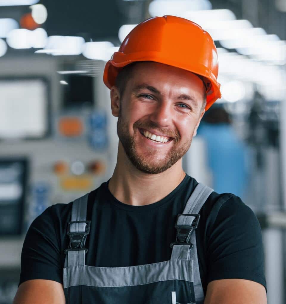 Guy wearing hard hat in factory